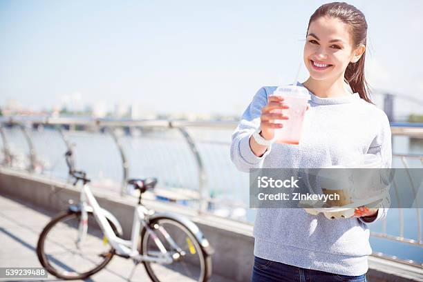 Smiling Woman Giving A Beverage Stock Photo - Download Image Now - Adult, Adults Only, Backgrounds