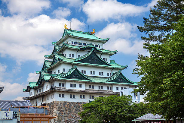 Nagoya, Japan - May 13, 2016: main tower of the Nagoya castle complex on a partly cloudy day.