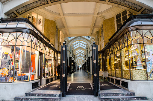 London, England - May 3, 2016: Entrance of the Burlington Arcade Shopping Mall with the stairs, and the luxury stores on both sides of the alley,  during a day of springtime.