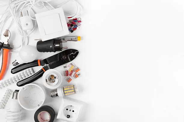 Photo of top view of electrical tools and equipment on white