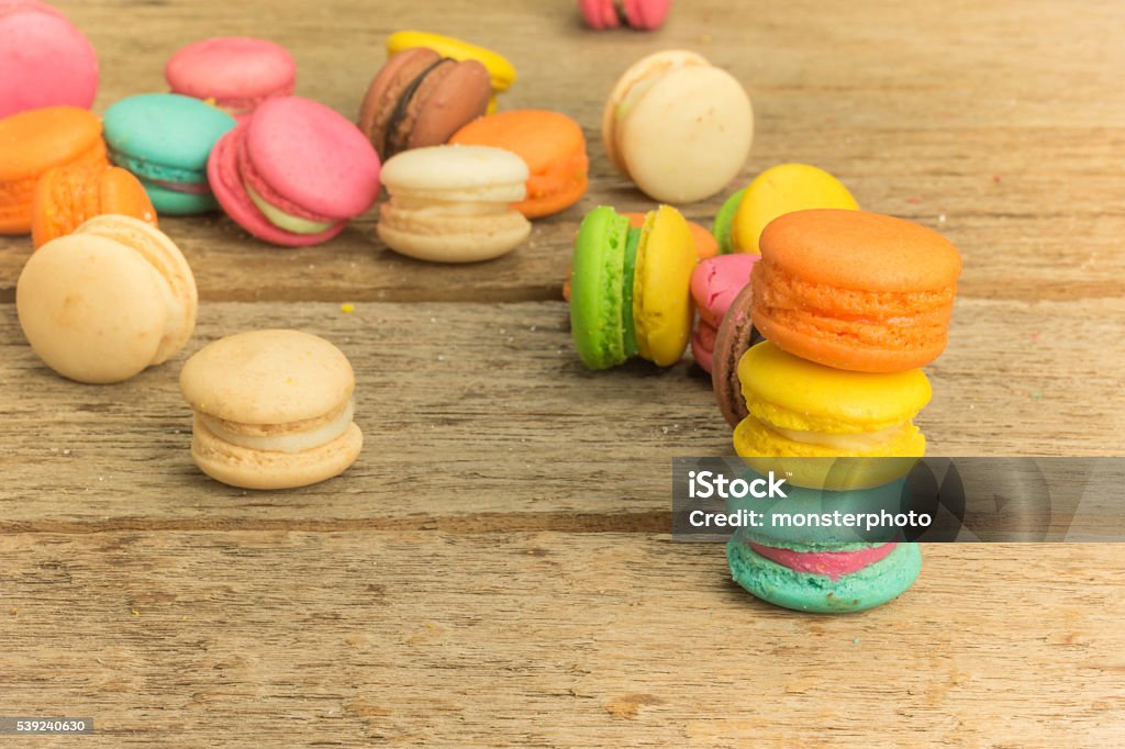 colorful macarons on a woody floor Backgrounds Stock Photo