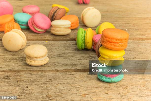 Colorful Macarons On A Woody Floor Stock Photo - Download Image Now - Backgrounds, Baked Pastry Item, Bakery