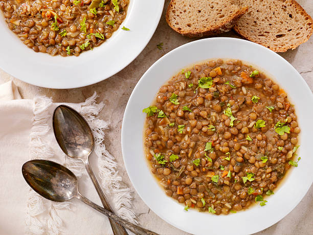 Lentil Soup with Crusty Bread Lentil Soup with Crusty Bread -Photographed on Hasselblad H3D2-39mb Camera soup lentil healthy eating dishware stock pictures, royalty-free photos & images