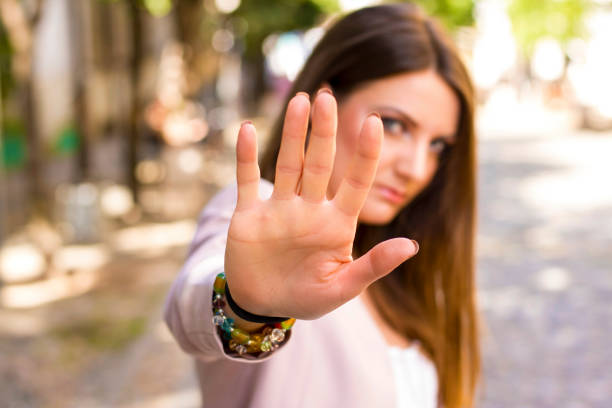 woman says stop Woman with her hand extended signaling to stop. Negative human emotion. Body language. Keep the distance self defense stock pictures, royalty-free photos & images