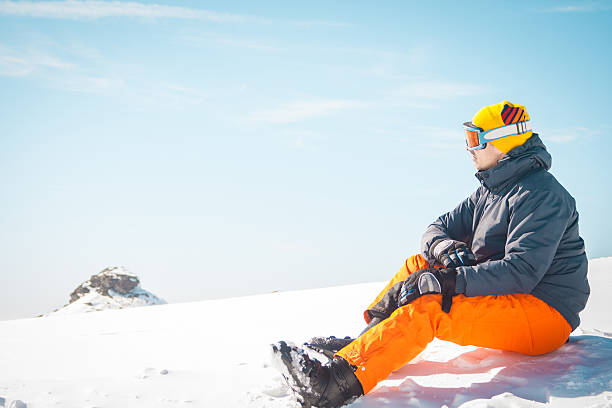 istock Male skier sitting on snow relaxing 539244445