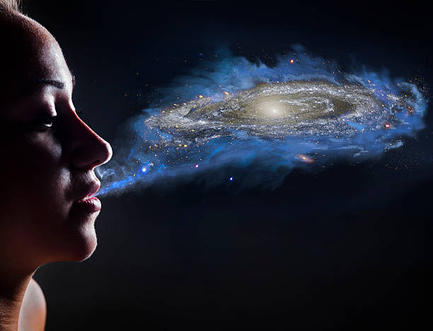 Mother nature Young woman blowing and creating universe ,copy space blond hair fine art portrait portrait women stock pictures, royalty-free photos & images