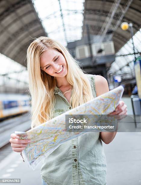Tourist In Amsterdam Looking Map Of The City Stock Photo - Download Image Now - 20-29 Years, 2015, Adult