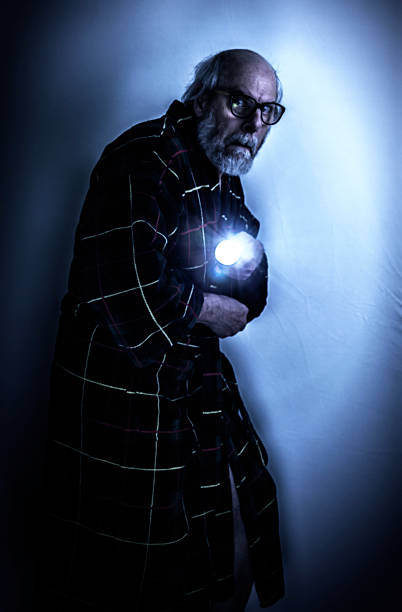 istock Scared Senior Man in Dark Room With Flashlight 539245127