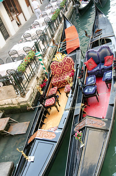 istock In a small Venice canal large and ornate empty gondolas. 539245155