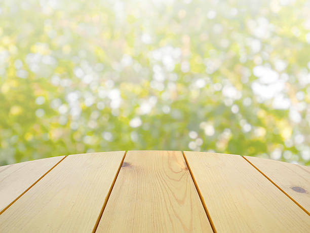 istock Wooden table on abstract green nature 539245194