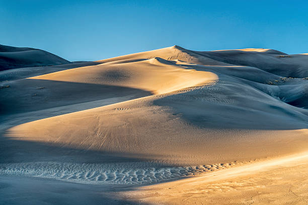 Great Sand Dunes National Park sand dunes patterns at sunset - Great Sand Dunes National Park in Colorado great sand dunes national park stock pictures, royalty-free photos & images