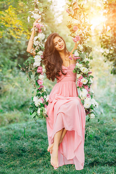istock Beautiful young girl on a swing 539245657