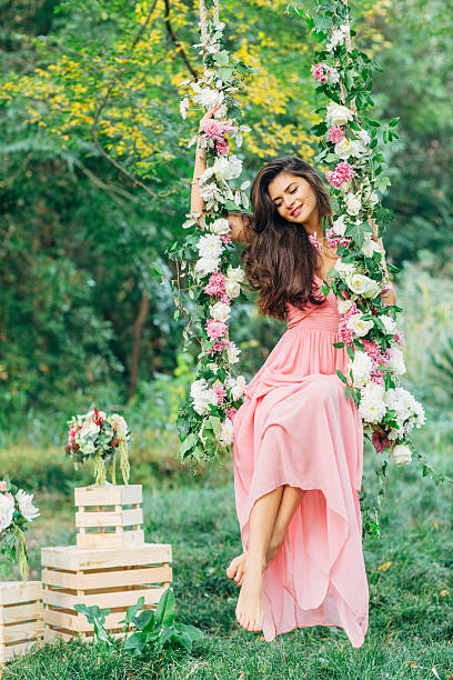 istock Beautiful young girl on a swing 539245917