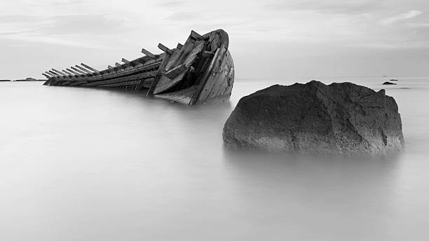 istock Wrecked Ship in the beach with stone 539246412