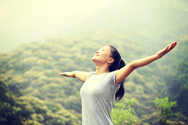 istock cheering hiking woman open arms at mountain peak 539246791