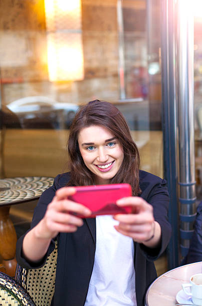 istock Young woman taking selfie with smart phone in cafe Paris 539246940