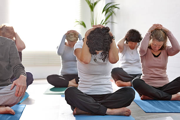 istock Group of people exercising during yoga class 539247039