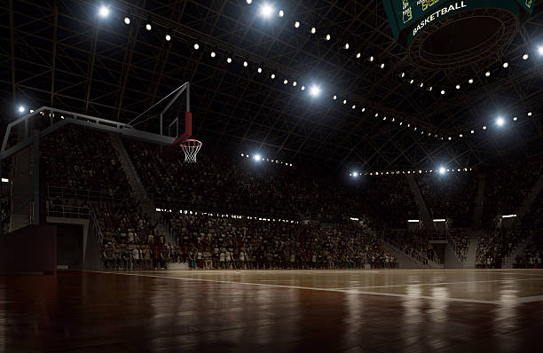 Basketball arena Indoor floodlit basketball arena full of spectators - full 3D sports court stock pictures, royalty-free photos & images