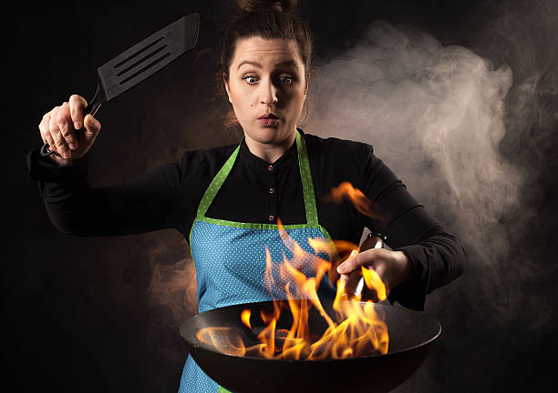 istock Fire cook woman - wok cooking 539247483