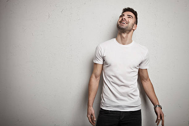 Smiling man in blank t-shirt stock photo