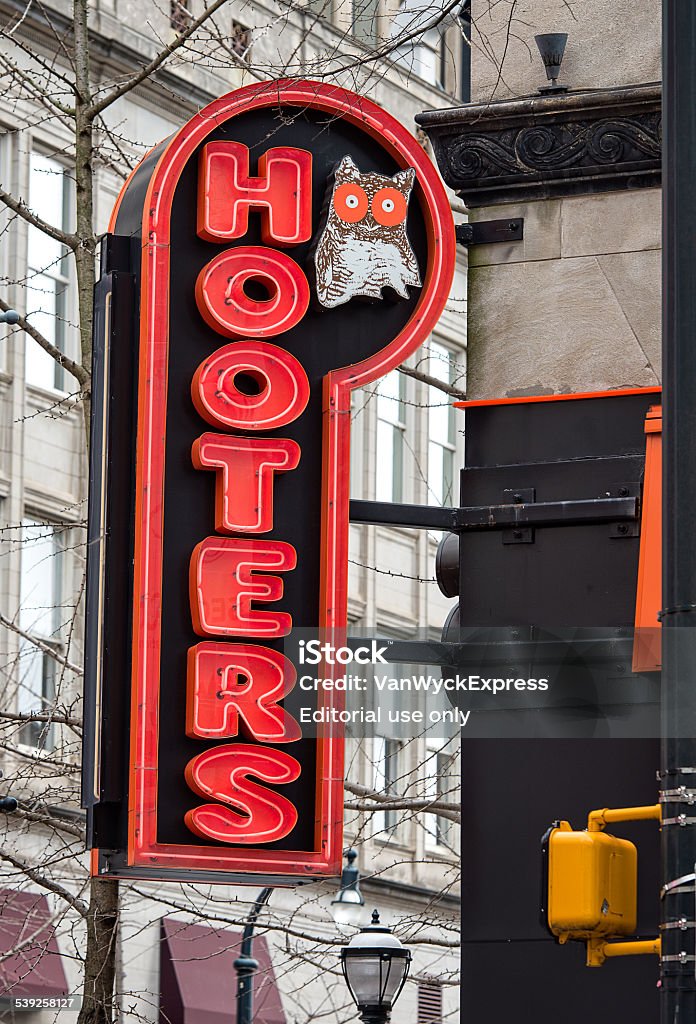 Hooters Sign Neon Atlanta, United States - March 6, 2015: Outside Hooters neon light sign on Peachtree Street in downtown Atlanta, Georgia. Hooters of America is the brandname of an American restaurant chain which can be found in 44 US states and 24 different countries al over the world. The 'Hooter' name is referring to the owl in the logo, but most will think of the voluptuous female waitresses when hearing the name Hooters. 2015 Stock Photo