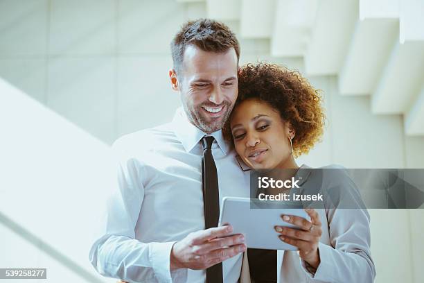 Elegance Couple Using A Digital Tablet Stock Photo - Download Image Now - Couple - Relationship, Luxury, Finance