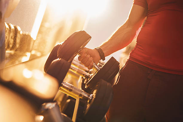istock Unrecognizable person taking dumbbells in a gym. 539258337