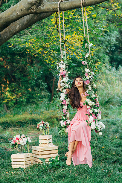 istock Beautiful young girl on a swing 539258751