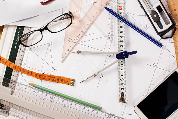 istock messy architect desk with paper, ruler, compasses and mobile phone 539258971