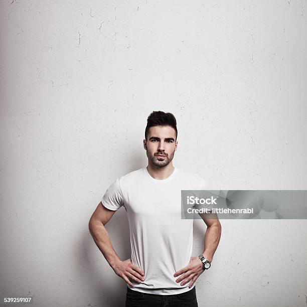 Man In Blank Tshirt And Wall Background Stock Photo - Download Image Now - Activity, Adult, Advertisement