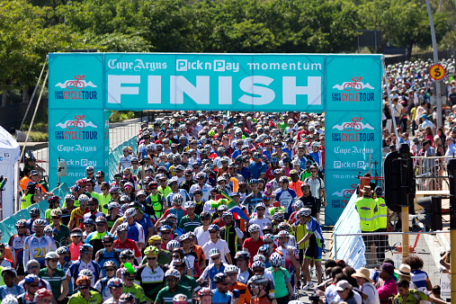 Cape Town, Western Cape, South Africa - March 8, 2015: Hundreds of cyclists crossing the finish line after completing the Cape Town Cycle Tour.