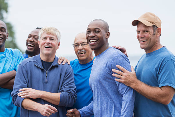 Diverse group of men standing together Multi-ethnic group of men standing together, smiling, supporting one another. Mixed ages ranging from 20s to 70s. only men stock pictures, royalty-free photos & images
