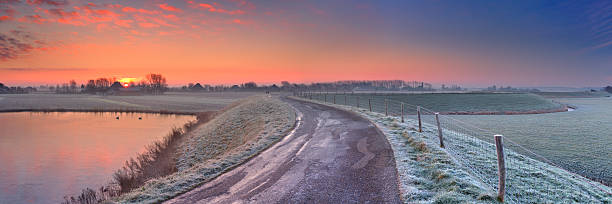 istock Typical Dutch landscape with a dike, in winter at sunrise 539260557