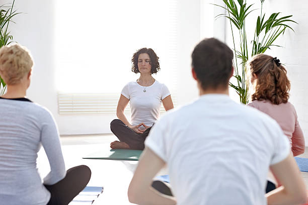 istock Group of people meditating in yoga class 539261297