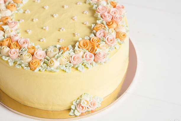 istock Pale yellow mousse cake with pastel cream flowers 539269411