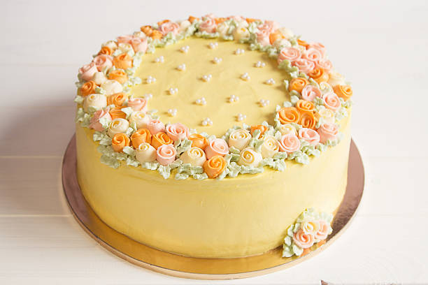 istock Pale yellow mousse cake with pastel cream flowers 539269413