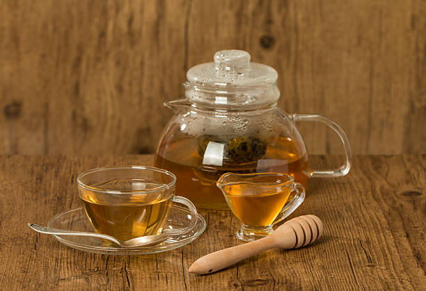 istock Glass cup and teapot with green tea with honey 539270211