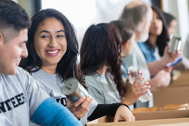 istock Hispanic couple sorting food donations while volunteering together 539270411