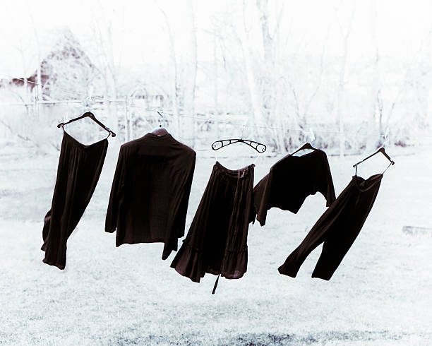 Clothes Ladies clothes hanging on a clothes line blowing in the wind. straight leg pants stock pictures, royalty-free photos & images