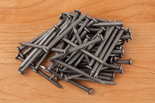 istock Pile of Nails on a Wood Background 539272099