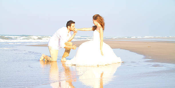 istock Bride and groom at beach 539279931
