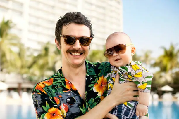 Photo of Father and his son with hawaian shirts