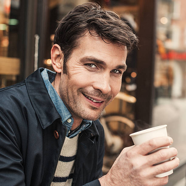 istock Man in drinking coffee outisde a cafe shop 539280185