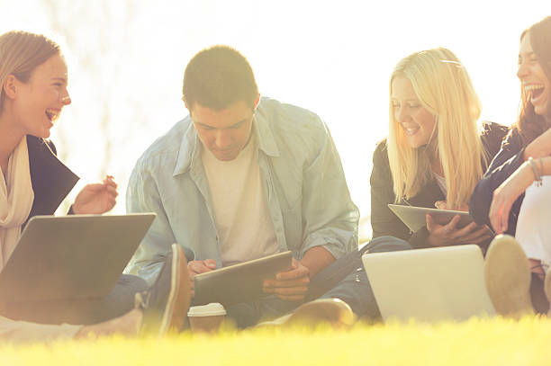 istock Group of young people using technology in the park. 539280207