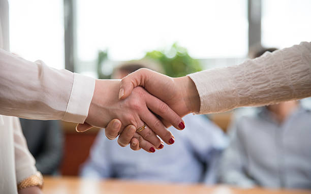 istock Two Women Shaking Hands in The Office 539280743