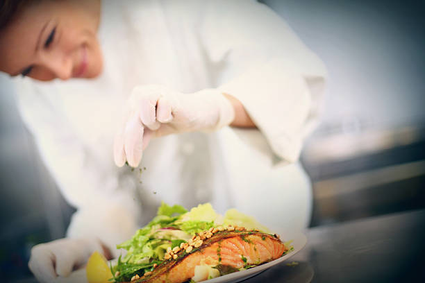 istock Professional chef places finishing touches on meal 539280855