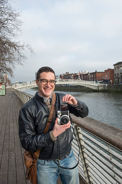 istock Photographer at Ha'Penny Bridge, Dublin, Ireland. 539281419