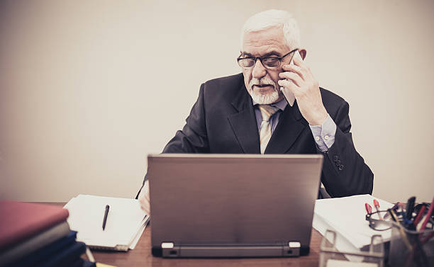 istock Business man over the cellphone while working on a laptop 539281701