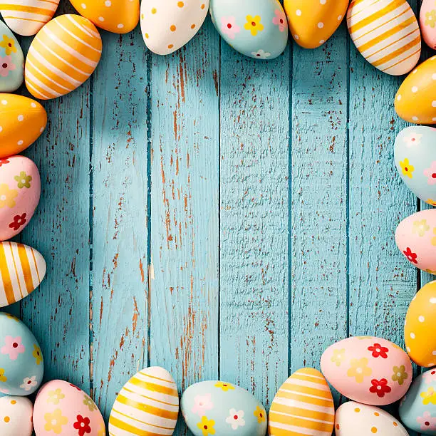 Close up photography of decorative multi colored easter eggs lying on vintage blue wood. Great for design for easter and spring related subject area. Photo captured with a Zeiss Makro-Planar T* 2/50mm at f8. 