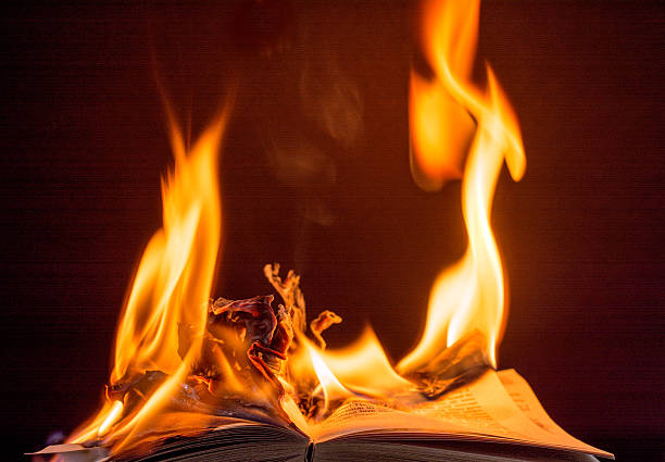 istock Burning book engulfed in brilliant  flames-  black background. 539291401